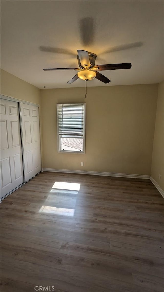 938 Stanley Ave, Long Beach, CA 90804 - unfurnished bedroom featuring a closet, ceiling fan, wood finished floors, and baseboards