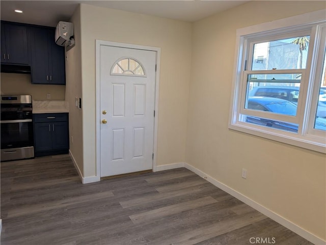 938 Stanley Ave, Long Beach, CA 90804 - foyer entrance featuring baseboards, a wall mounted air conditioner, and dark wood-style floors