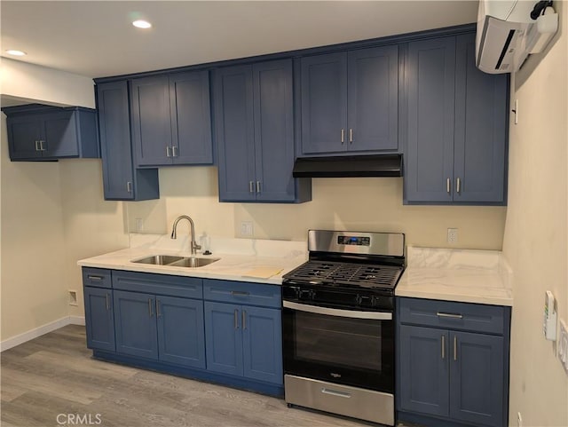 938 Stanley Ave, Long Beach, CA 90804 - kitchen with blue cabinetry, stainless steel gas stove, under cabinet range hood, a sink, and a wall unit AC