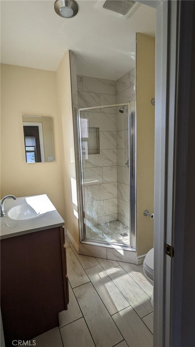 938 Stanley Ave, Long Beach, CA 90804 - bathroom with toilet, visible vents, a shower stall, and vanity