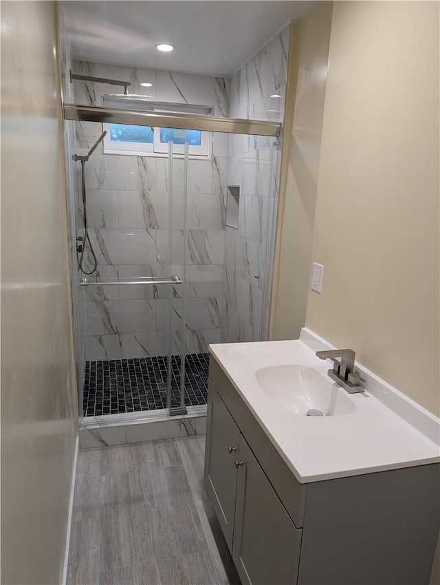 938 Stanley Ave, Long Beach, CA 90804 - bathroom with a marble finish shower, wood finished floors, and vanity