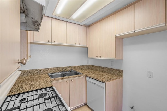 kitchen with a sink, dishwasher, stovetop, and light brown cabinetry