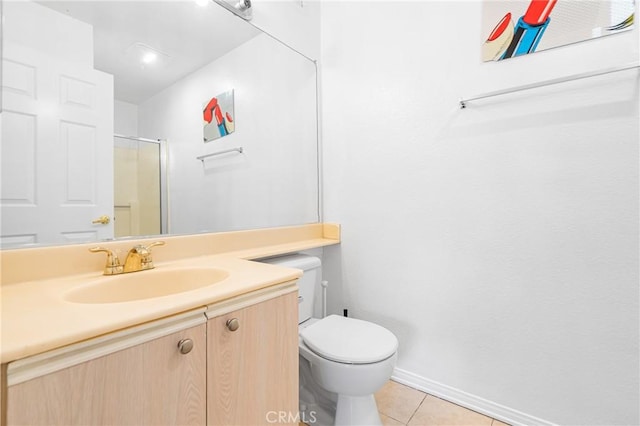 bathroom featuring tile patterned flooring, vanity, toilet, baseboards, and a shower with shower door