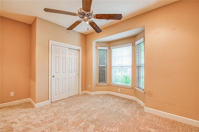 unfurnished bedroom featuring baseboards, carpet flooring, and a closet