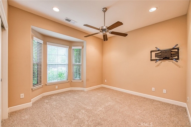 carpeted empty room featuring visible vents, a ceiling fan, recessed lighting, and baseboards