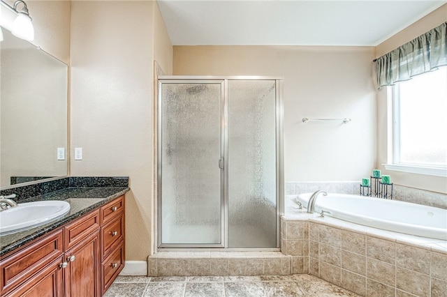 bathroom featuring tile patterned floors, a garden tub, vanity, and a stall shower
