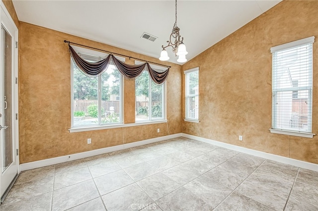unfurnished room with baseboards, visible vents, a notable chandelier, and lofted ceiling
