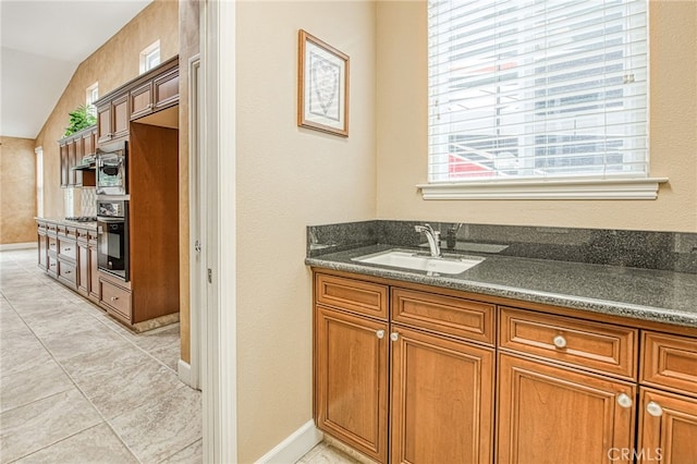 bathroom featuring a sink, tile patterned floors, and baseboards