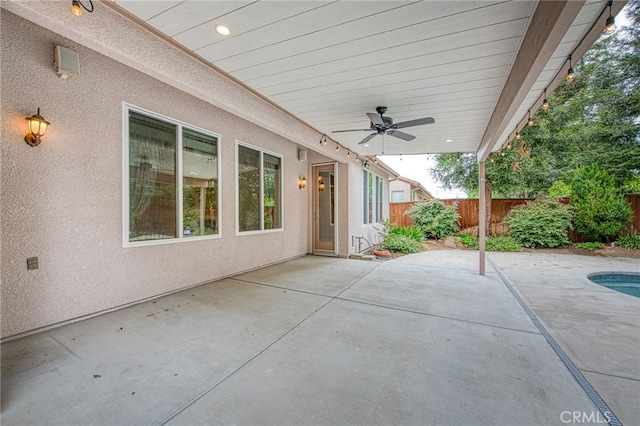 view of patio with ceiling fan, a fenced backyard, and a fenced in pool