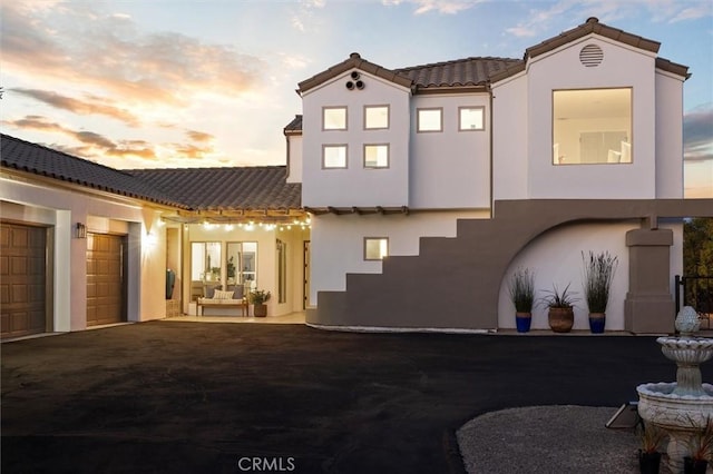 10815 San Marcos Rd, Atascadero, CA 93422 - rear view of house with a garage, a tile roof, and stucco siding