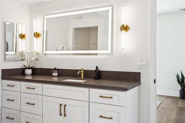 10815 San Marcos Rd, Atascadero, CA 93422 - bathroom featuring vanity, baseboards, wood finished floors, and visible vents