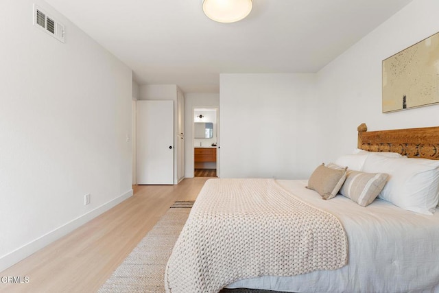 4490 Lubbock Dr Unit D, Simi Valley, CA 93063 - bedroom with light wood-style floors, baseboards, ensuite bathroom, and visible vents