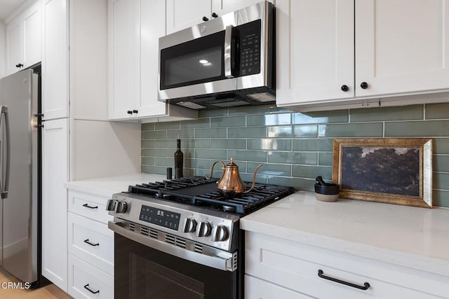 4490 Lubbock Dr Unit D, Simi Valley, CA 93063 - kitchen featuring light stone counters, decorative backsplash, stainless steel appliances, and white cabinets