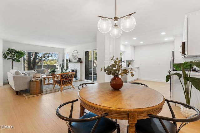 4490 Lubbock Dr Unit D, Simi Valley, CA 93063 - dining space with a brick fireplace, recessed lighting, baseboards, and light wood-style flooring