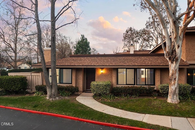 4490 Lubbock Dr Unit D, Simi Valley, CA 93063 - single story home featuring a lawn, fence, a chimney, and stucco siding
