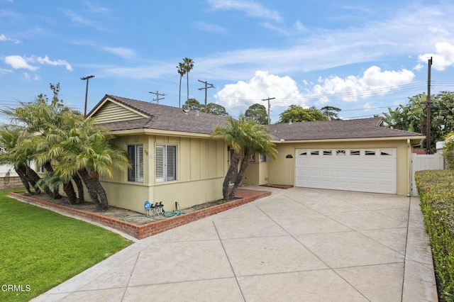 ranch-style home with fence, driveway, a front yard, and a garage