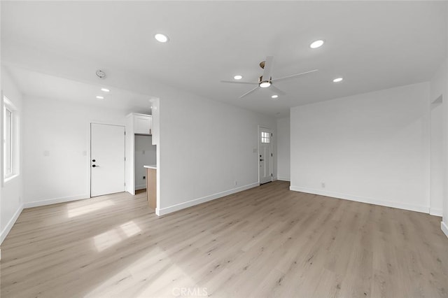 unfurnished living room featuring baseboards, recessed lighting, ceiling fan, and light wood-style floors