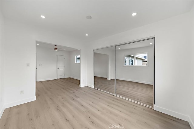 unfurnished bedroom featuring baseboards, recessed lighting, and light wood-style floors