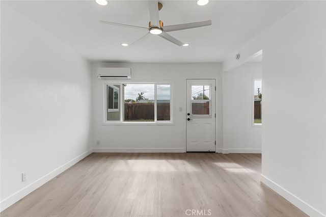 entrance foyer with light wood-style floors, a ceiling fan, an AC wall unit, and recessed lighting