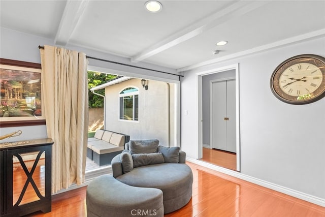 sitting room with recessed lighting, beam ceiling, wood finished floors, and baseboards