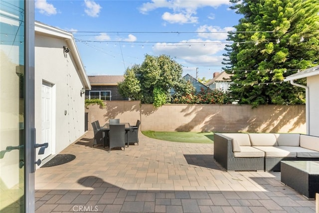 view of patio / terrace with an outdoor living space, outdoor dining space, and fence private yard
