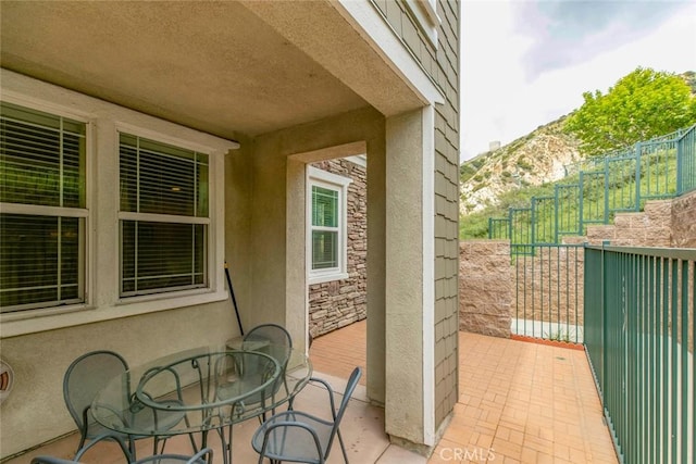 view of patio / terrace with fence and a mountain view