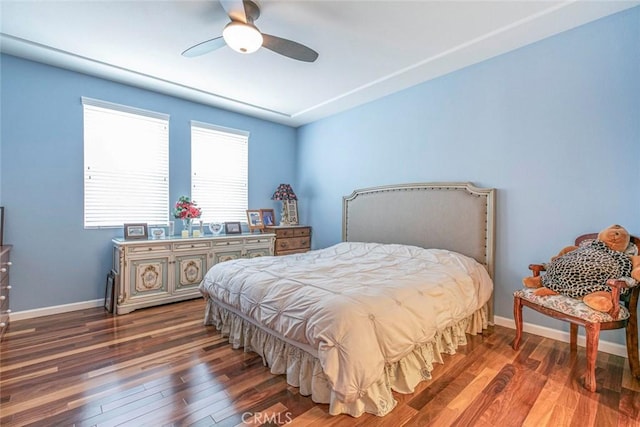 bedroom with baseboards, a ceiling fan, and wood finished floors