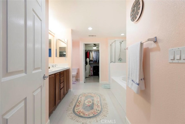 full bathroom featuring vanity, toilet, tile patterned floors, a washtub, and an enclosed shower