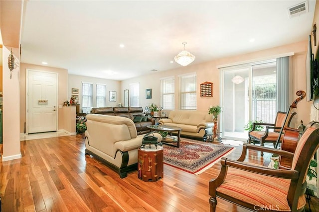 living area featuring visible vents, recessed lighting, light wood-style flooring, and baseboards