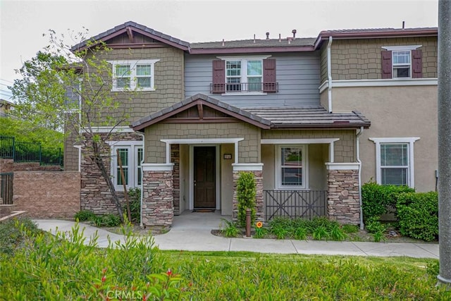 craftsman house featuring stone siding