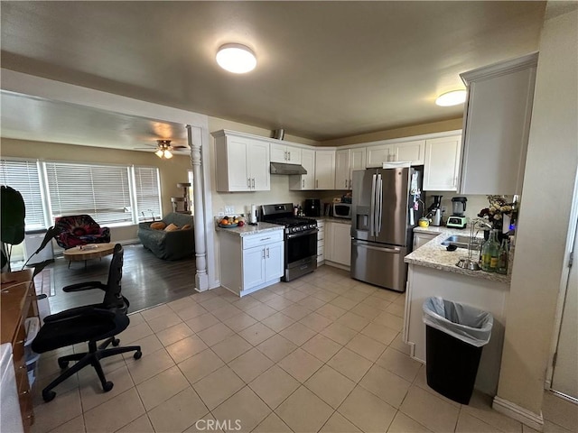 325 E 59th, Long Beach, CA 90805 - kitchen featuring appliances with stainless steel finishes, light tile patterned floors, light stone countertops, a sink, and under cabinet range hood
