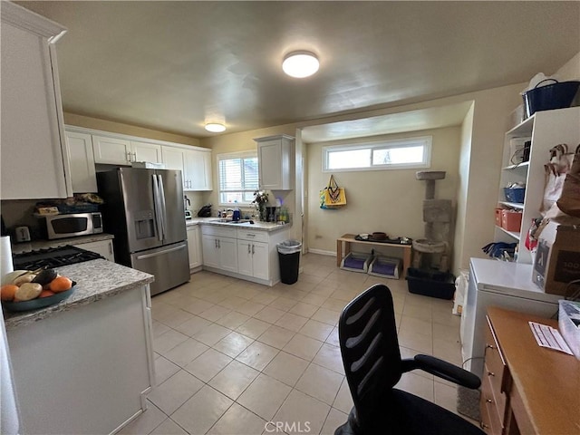 325 E 59th, Long Beach, CA 90805 - kitchen featuring appliances with stainless steel finishes, light tile patterned floors, white cabinetry, and a sink