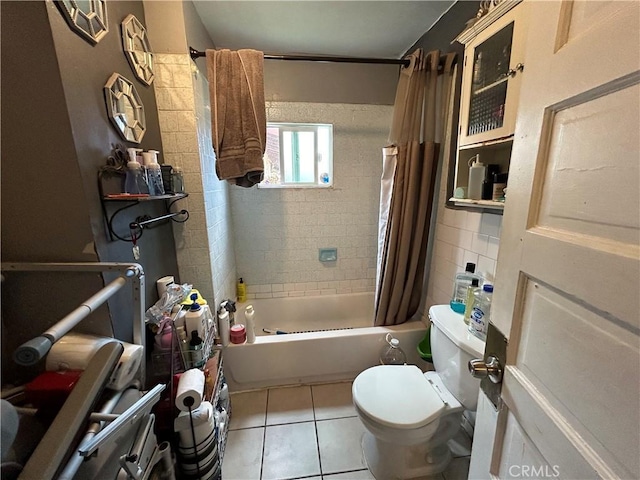 full bath featuring shower / bathtub combination with curtain, tile patterned floors, and toilet