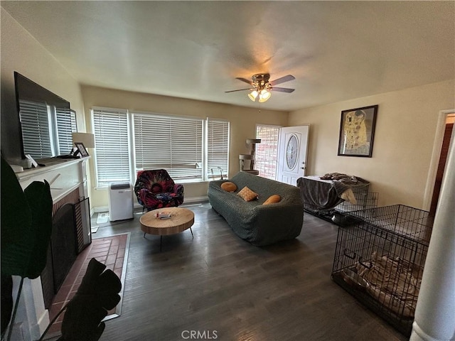 325 E 59th, Long Beach, CA 90805 - living area featuring a ceiling fan, wood finished floors, a fireplace with raised hearth, and baseboards