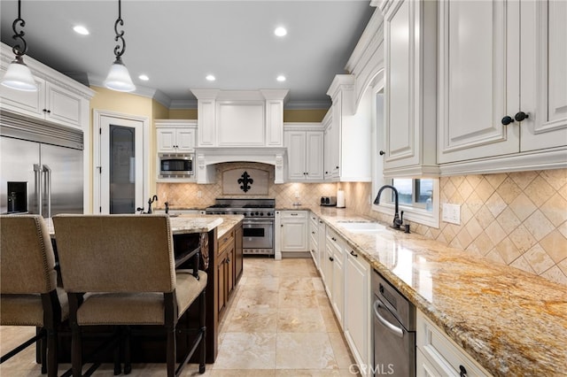 kitchen with built in appliances, a sink, white cabinetry, light stone countertops, and recessed lighting