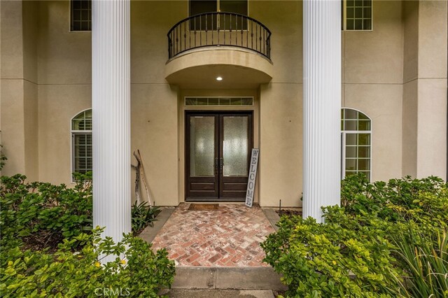 280 W 26th St, Upland, CA 91784 - view of exterior entry with a balcony, french doors, and stucco siding