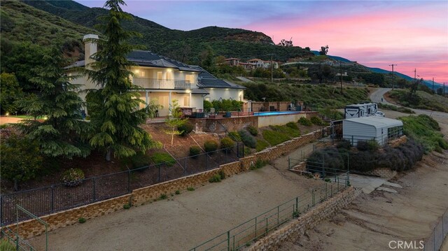 280 W 26th St, Upland, CA 91784 - view of side of home with a mountain view, stucco siding, and fence