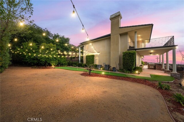 280 W 26th St, Upland, CA 91784 - rear view of property featuring a putting area, a balcony, a patio, stucco siding, and a chimney
