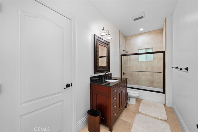 bathroom with vanity, bath / shower combo with glass door, toilet, and baseboards