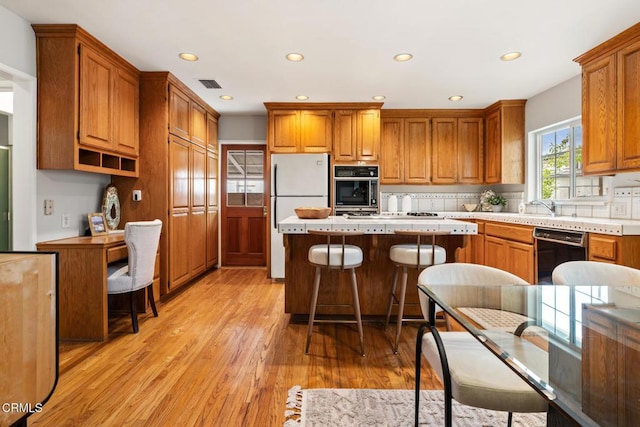 kitchen featuring visible vents, freestanding refrigerator, oven, recessed lighting, and black dishwasher