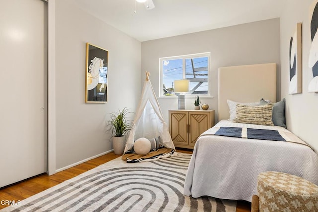bedroom featuring baseboards and wood finished floors