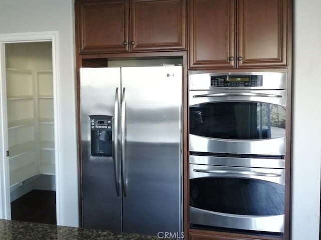 1027 Palmetto Way, Costa Mesa, CA 92626 - kitchen featuring appliances with stainless steel finishes and dark stone countertops