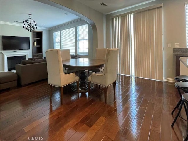 1027 Palmetto Way, Costa Mesa, CA 92626 - dining room with visible vents, arched walkways, crown molding, and hardwood / wood-style flooring