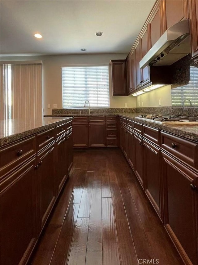 1027 Palmetto Way, Costa Mesa, CA 92626 - kitchen featuring dark wood-type flooring, dark stone countertops, stainless steel gas cooktop, and under cabinet range hood