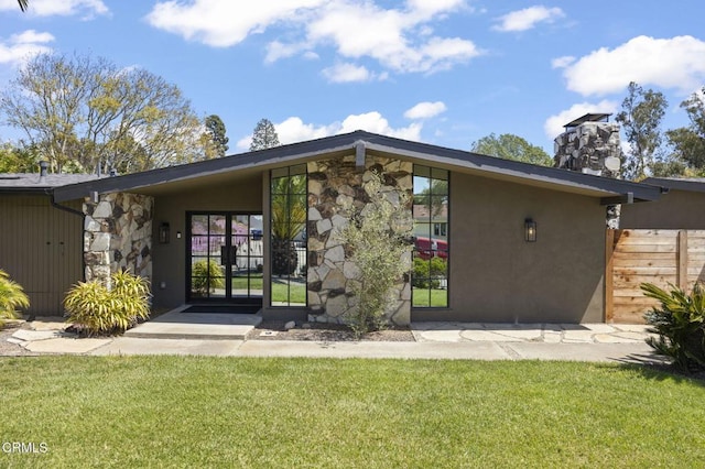 1820 Ramona Dr, Camarillo, CA 93010 - back of property with a lawn, a chimney, stone siding, and stucco siding