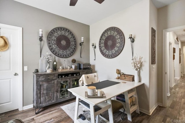 dining area featuring a ceiling fan, baseboards, and wood finished floors