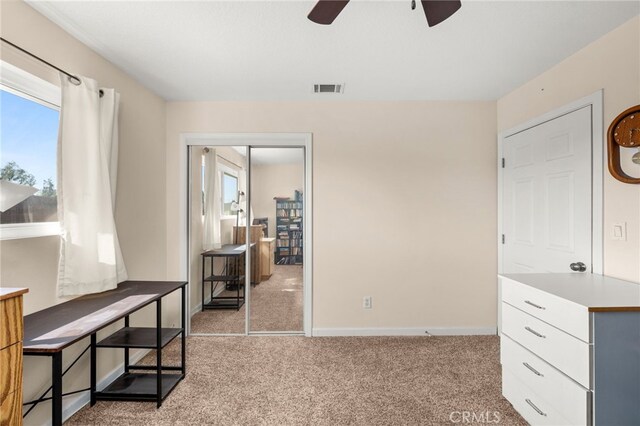 interior space featuring baseboards, carpet flooring, and visible vents