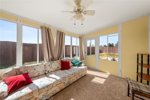 sunroom / solarium with vaulted ceiling and carpet flooring