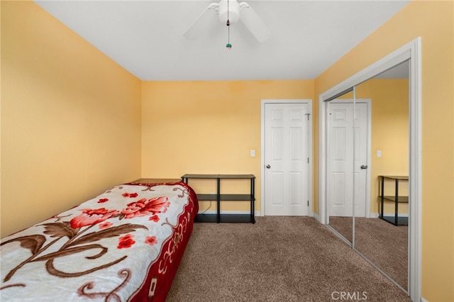 bedroom featuring a closet, carpet floors, baseboards, and a ceiling fan