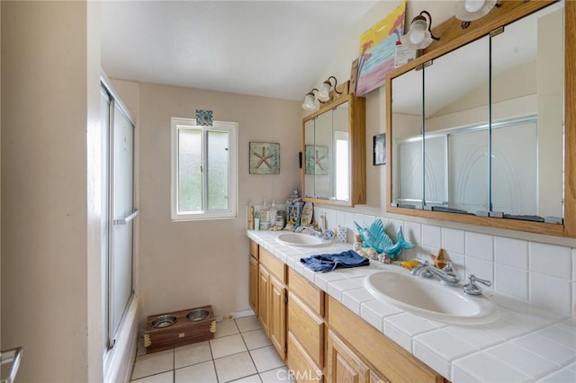 24851 Stem Ave, Lake Forest, CA 92630 - full bath featuring double vanity, a shower with shower door, decorative backsplash, and tile patterned flooring